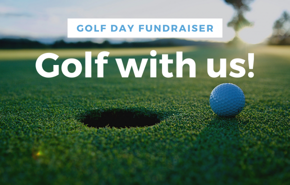 a close up of a golf ball next to a hole