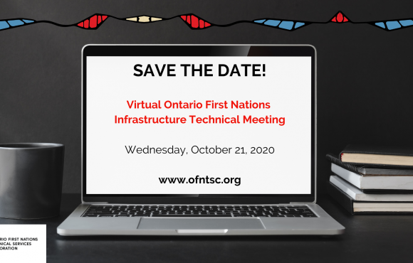 A laptop computer is open on a desk with the words "Save the Date" on the screen. A black mug is on the table to the left of the computer, and a stack of notebooks with a pen on top is situated to the right of the laptop.