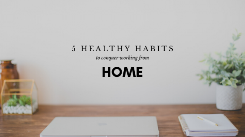 A home working station, desk, papers, and plants on a table