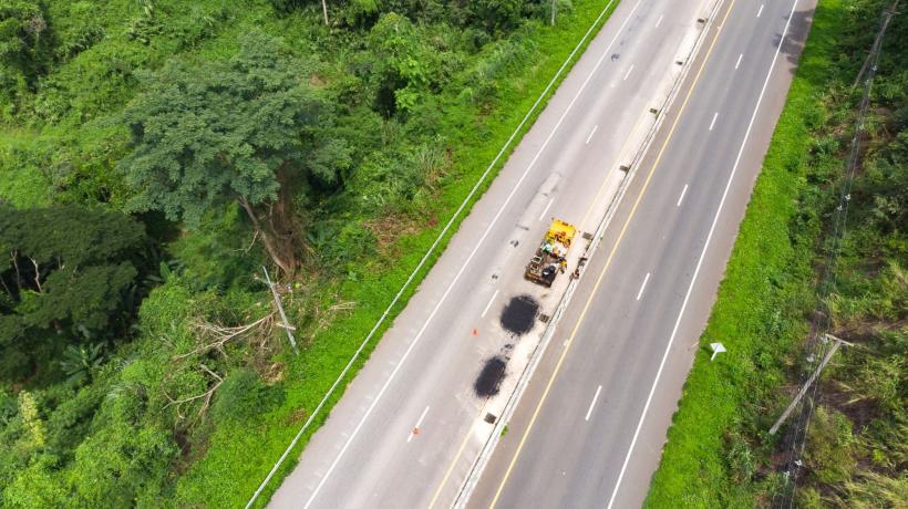An aerial view of a road with construction vehicles on it