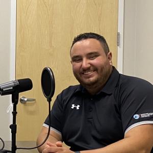 chelsey and nate sit at the podcast table.